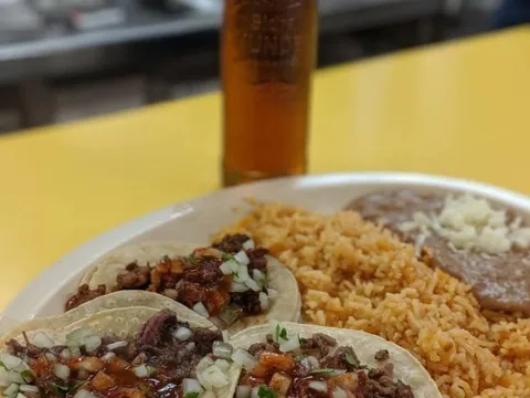 A plate of tacos with rice and beans at El Taco de Mexico